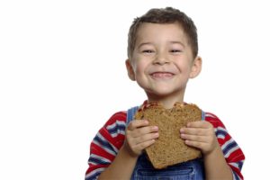 Boy with Peanut Butter and Jelly Sandwich on Whole Wheat